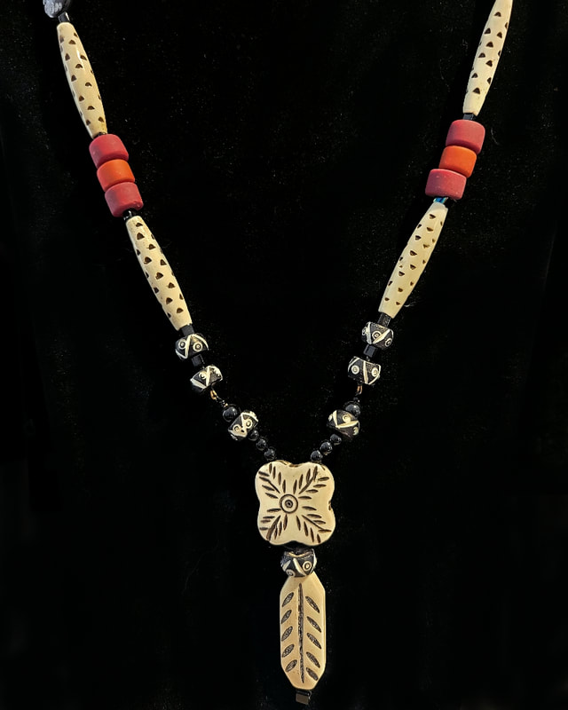 One-of-a-kind necklace with bone and coral beads. Linda Levy has been creating Jewelry, Necklaces, Earrings, Gemstone jewelry, handcrafted, original art, in Santa Cruz California

