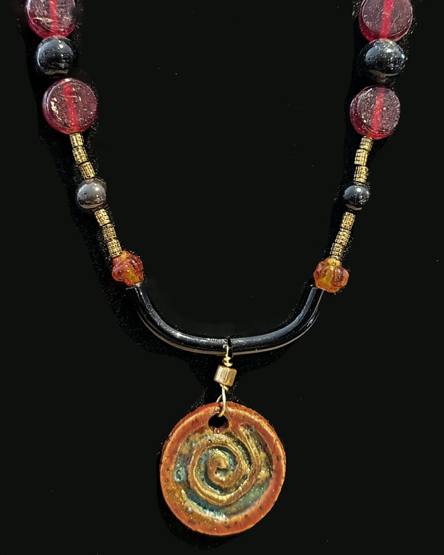 Glass beads and handmade ceramic focal by LA Levy.  Linda Levy has been creating Jewelry, Necklaces, Earrings, Gemstone jewelry, handcrafted, original art, in Santa Cruz California
