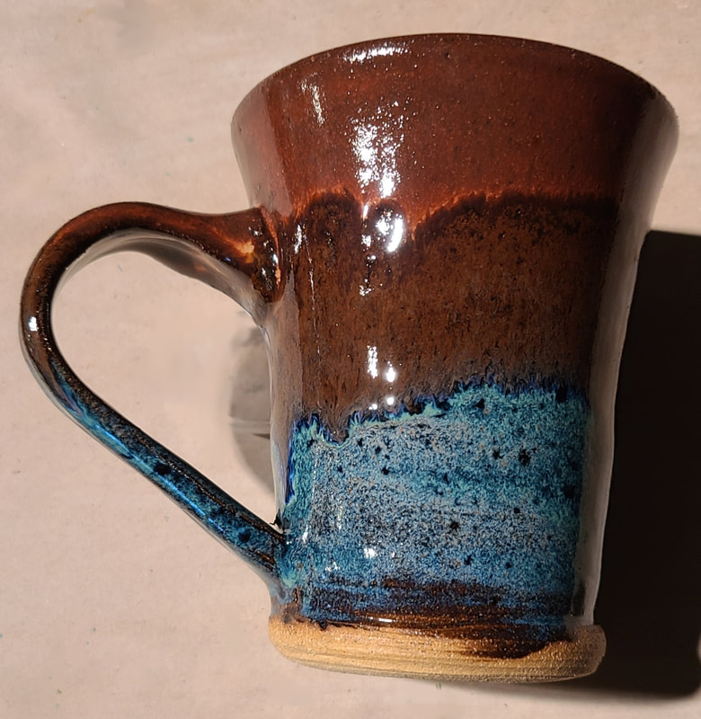 Ceramic Mug #1 - Clay has called to Linda Levy for over 50 years.  She has learned wheel throwing techniques, handbuilding, as well as glaze chemistry.  Her latest sculptural works are inspired by working with live models.  Linda's handbuilt plates and platters usually use her hand-created ceramic rollers to impart designs & textures.