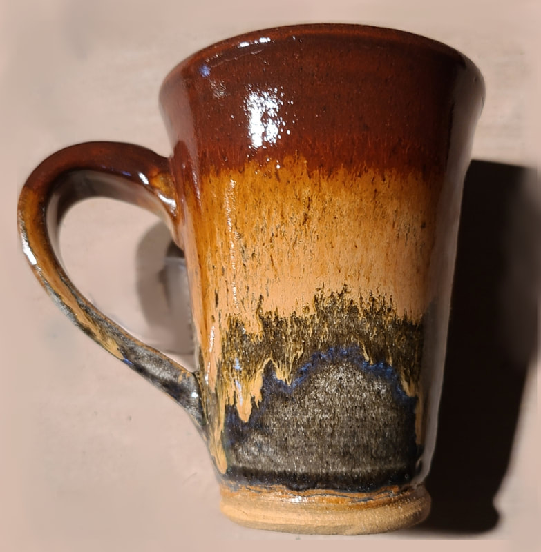 Ceramic Mug #2 - Clay has called to Linda Levy for over 50 years.  She has learned wheel throwing techniques, handbuilding, as well as glaze chemistry.  Her latest sculptural works are inspired by working with live models.  Linda's handbuilt plates and platters usually use her hand-created ceramic rollers to impart designs & textures.
