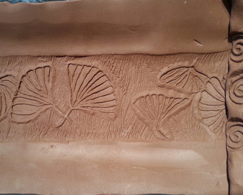 Raw, unfired clay platter using a Ginko Leaf design. 
 Linda Levy's handbuilt plates and platters use her hand-created ceramic rollers to impart designs & textures on her ceramics, ceramicist, ceramic art, sculpture, and ceramic sculpture.
