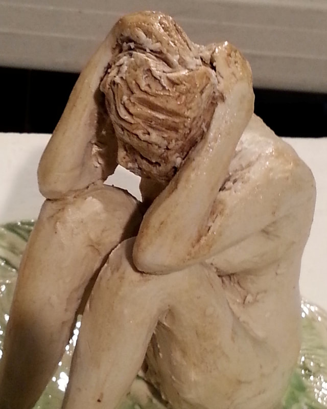 Detail of "Isolation" sculpture, a model for a larger sculpture.  Linda Levy's handbuilt figurative sculptures are created using a subtractive method, and are complimented by the use of her hand-created ceramic rollers to impart designs & textures on her ceramics, ceramicist, ceramic art, sculpture, and ceramic sculpture.